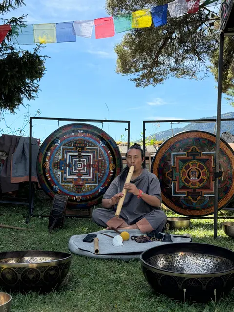 Pasang Lama jouant entre les gongs mandalas en plein air