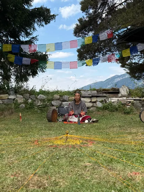 Pasang Lama jouant entre les gongs mandalas en plein air